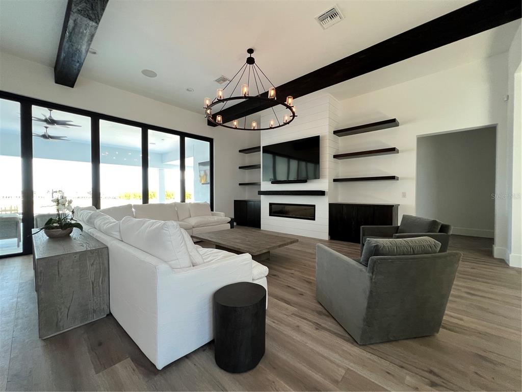 17710 Broad Street Montverde, FL 34756 - Photo 29 of 34 a living room with furniture and a fireplace