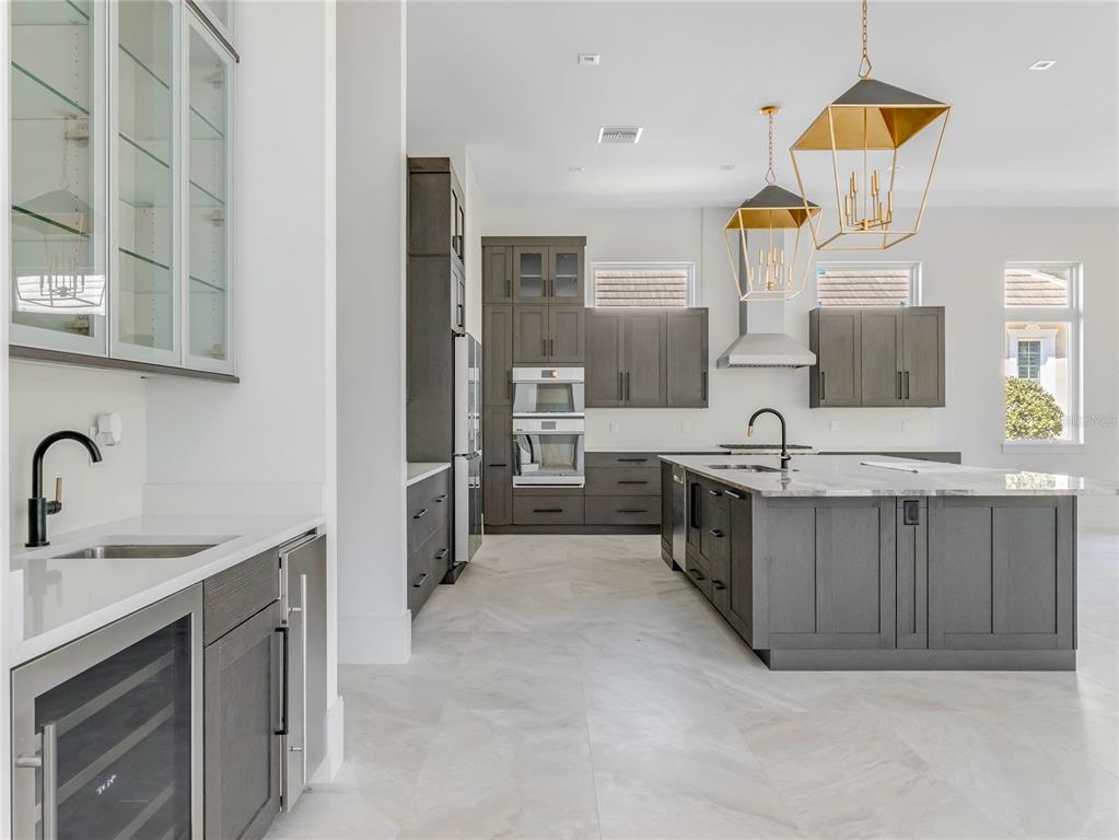 17710 Broad Street Montverde, FL 34756 - Photo 5 of 34 a kitchen with a sink and a stove top oven