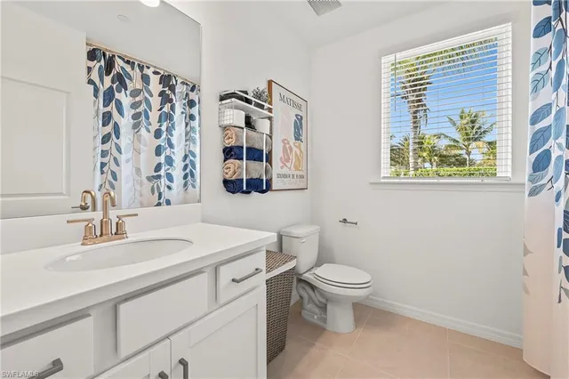 a bathroom with a sink toilet and a mirror
