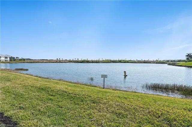 a view of a lake with houses in the back