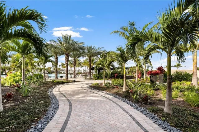 a row of palm trees sitting in front of a house