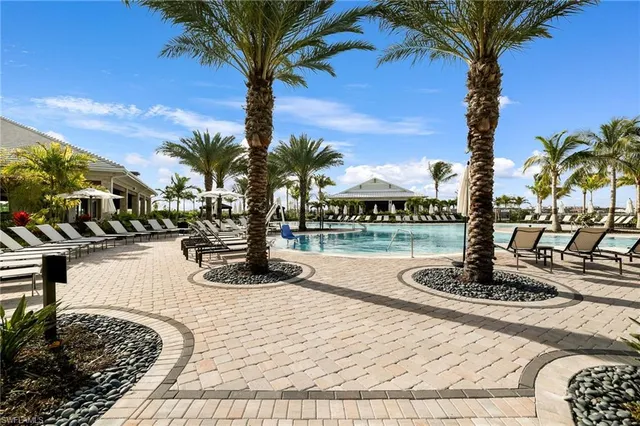 a swimming pool with outdoor seating
