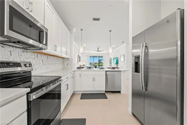 a kitchen with a sink stainless steel appliances and cabinets