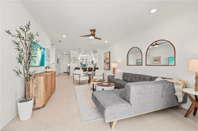 a living room with furniture and a potted plant