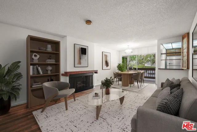 a living room with furniture hard wood floor and a rug