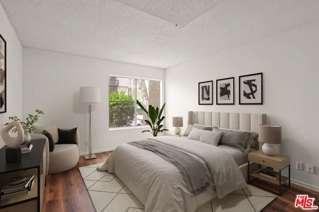 a bedroom with a large bed and a couch