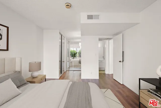 a bedroom with furniture and a wooden floor