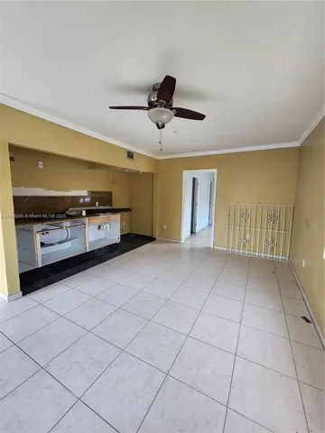 a view of a kitchen with furniture and a ceiling fan