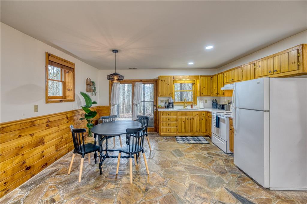 357 Mystic Lane Blue Ridge, GA 30513 - Photo 26 of 58 a kitchen with refrigerator cabinets dining table and chairs