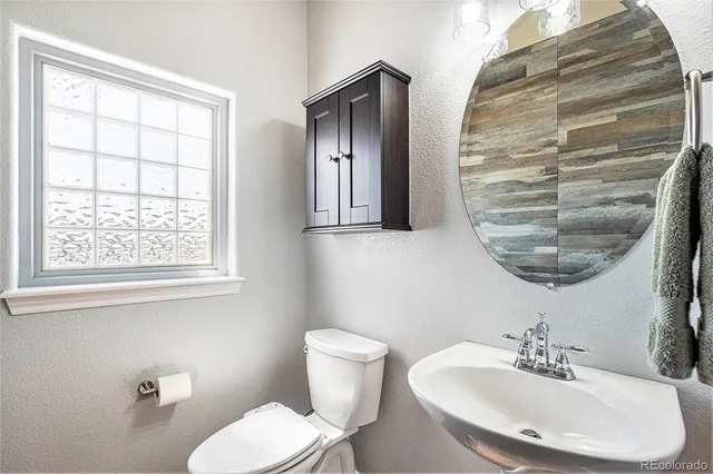 a bathroom with a granite countertop double vanity sink and a mirror
