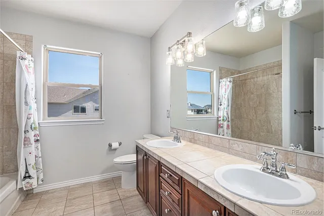 a spacious bathroom with double vanity sinks and a mirror