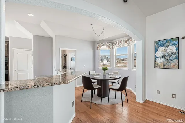 a bedroom with a large bed a flat tv screen and a potted plant