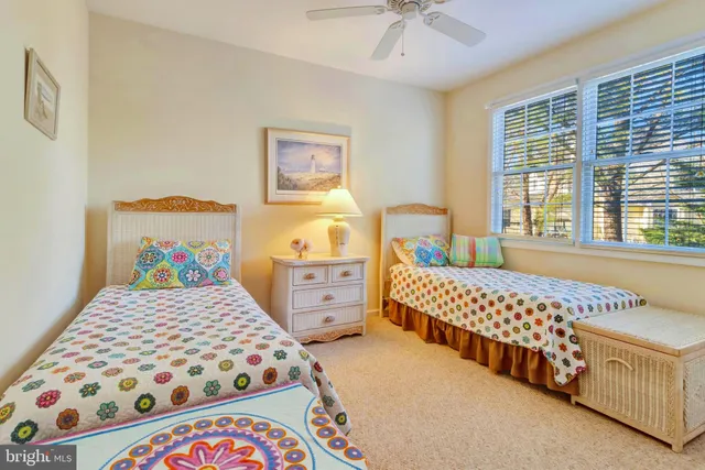 a bedroom with a bed and a lamp on dresser