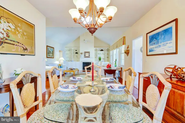 a dining room with furniture and chandelier