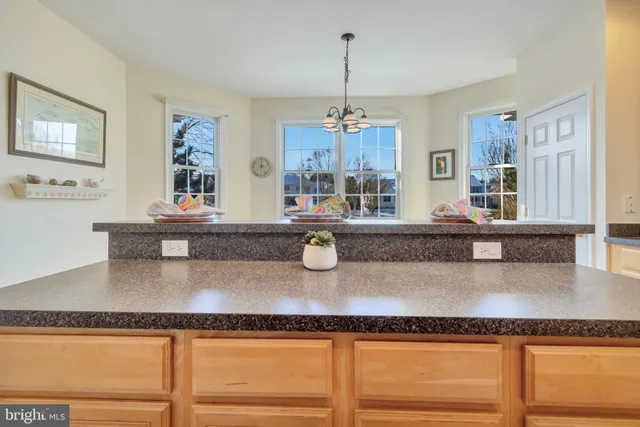 a kitchen with granite countertop a table and chairs