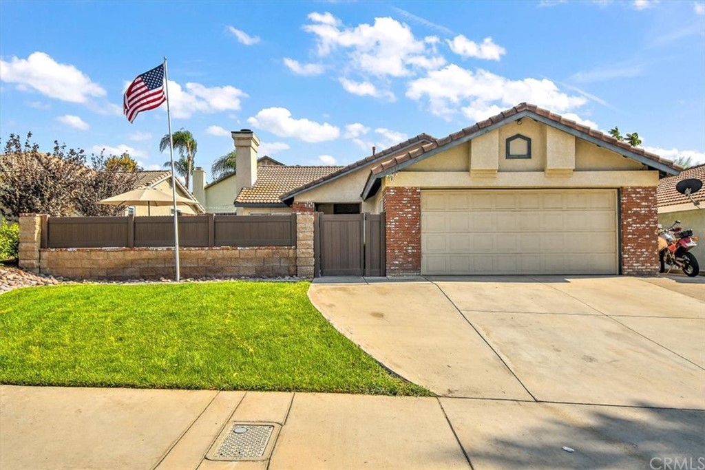 19937 Windwood Circle Riverside, CA 92508 - Photo 1 of 1 a front view of a house with a yard and garage