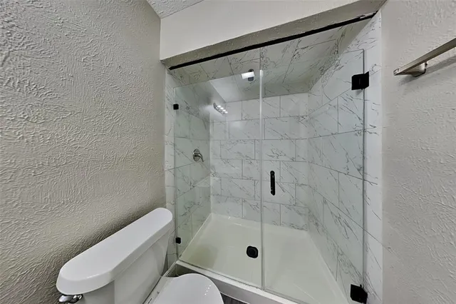 an empty room with a window and a ceiling fan