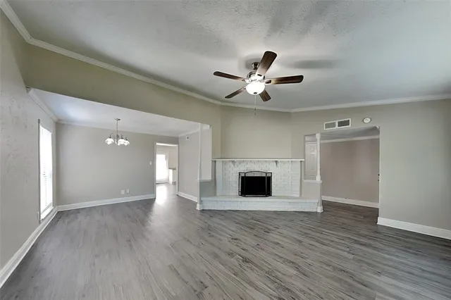 wooden floor in an empty room with a fireplace