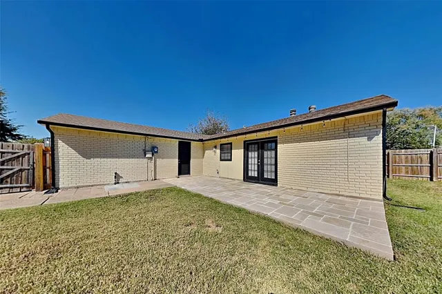 a front view of a house with wooden fence