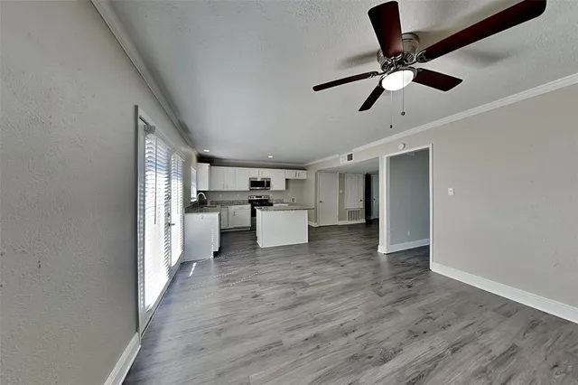 a view of a kitchen with a sink and stainless steel appliances