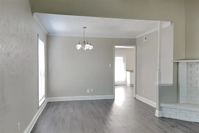 a kitchen with wooden floors and appliances