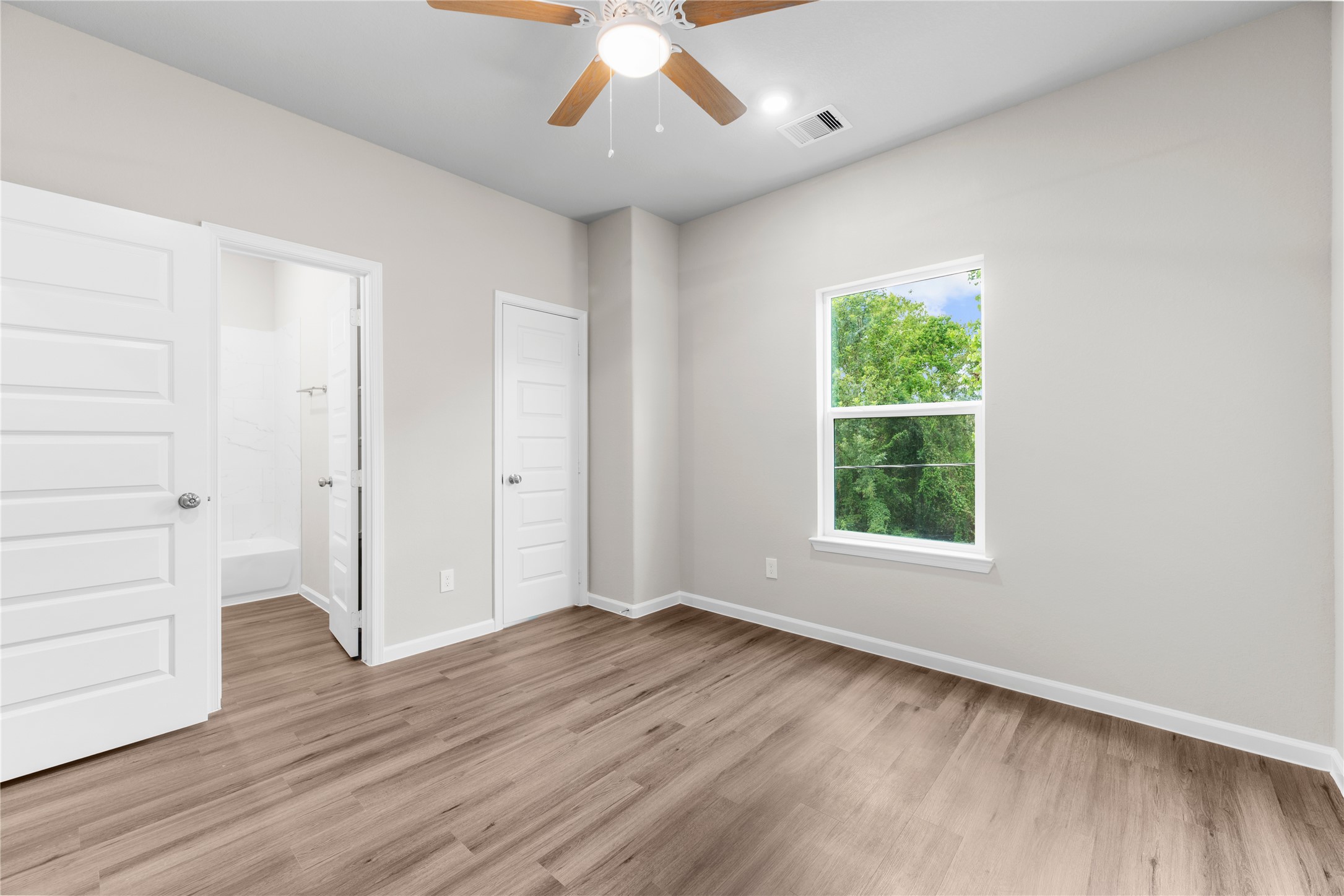 8161 Tate Street, Unit B Houston, TX 77028 - Photo 13 of 14 an empty room with wooden floor cabinet and windows