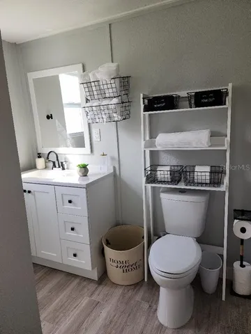 a bathroom with a toilet a sink and a mirror