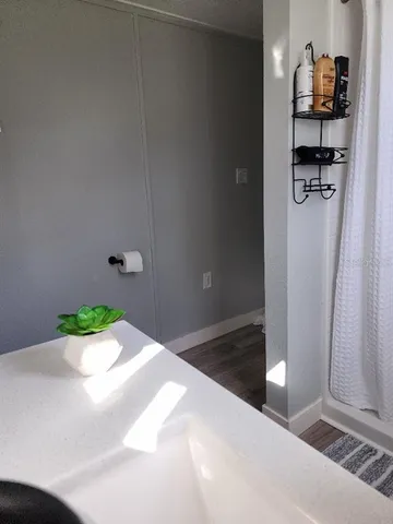 a bedroom with a bed and a potted plant