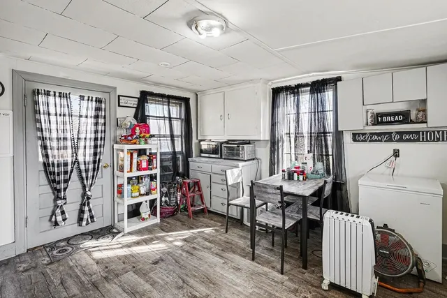 a room with furniture a flat screen tv and a window