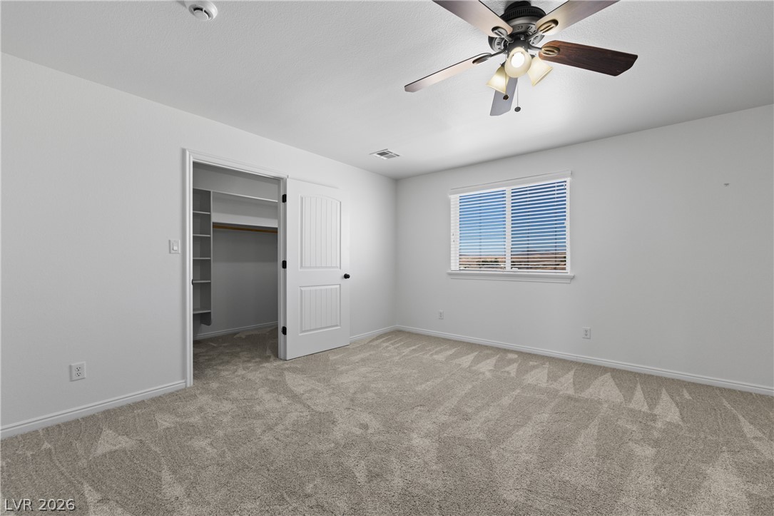 575 Gann Avenue Logandale, NV 89021 - Photo 46 of 75 A well-lit bedroom provides comfortable living with carpeted floors and a spacious closet.