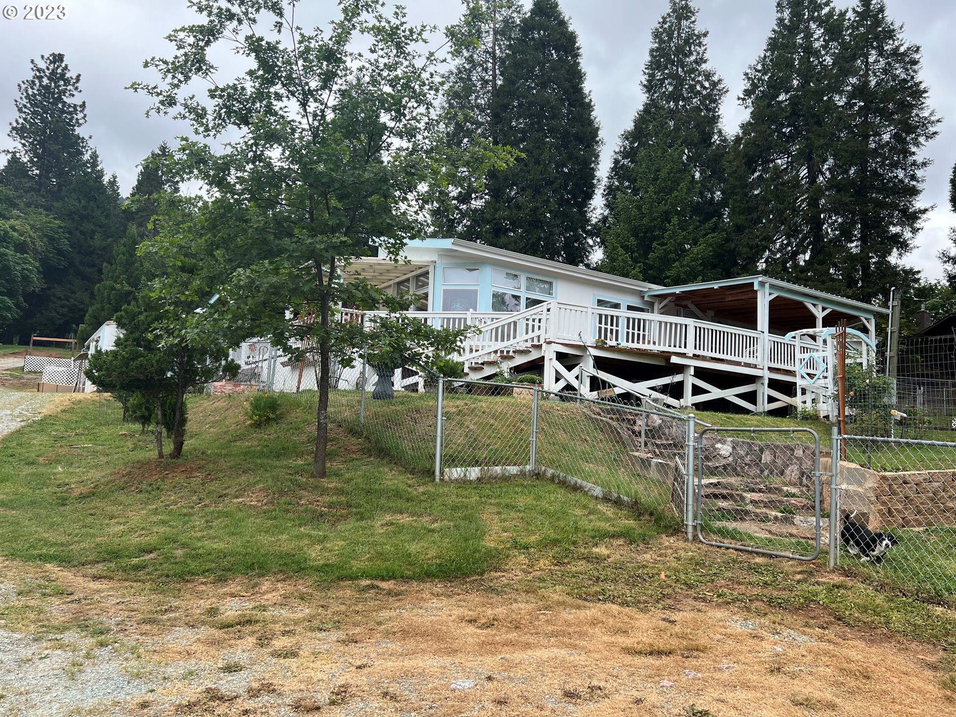 514 Canyonville-Riddle Road Riddle, OR 97469 - Photo 1 of 27 a view of a house with a yard