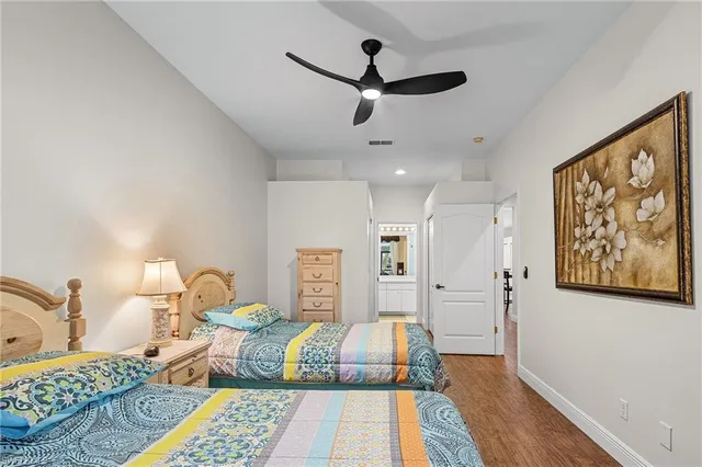 a bed room with a bed and a painting on the wall