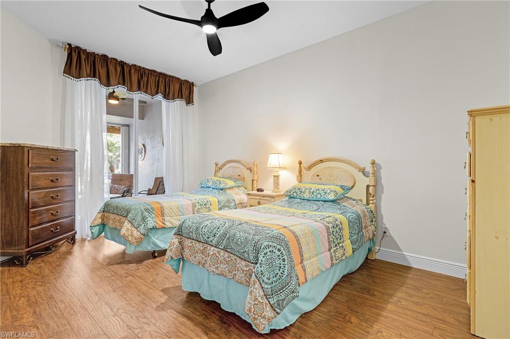 20681 Country Barn Drive Estero, FL 33928 - Photo 14 of 42 a bedroom with a bed and wooden floor
