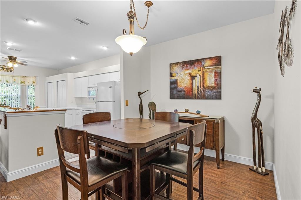 20681 Country Barn Drive Estero, FL 33928 - Photo 17 of 42 a view of a dining room with furniture and wooden floor