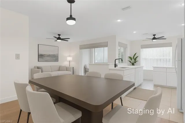 a view of kitchen island with stainless steel appliances a sink and living room view