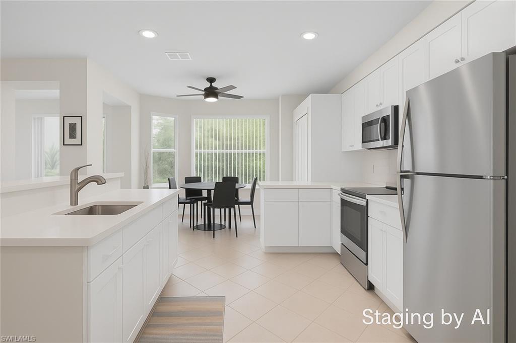 20681 Country Barn Drive Estero, FL 33928 - Photo 22 of 42 a kitchen with granite countertop a refrigerator a stove a dining table and chairs