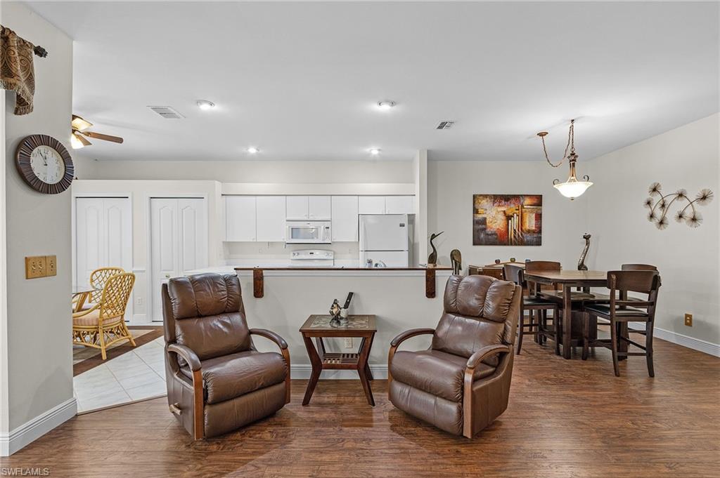20681 Country Barn Drive Estero, FL 33928 - Photo 25 of 42 a living room with furniture kitchen view and a wooden floor