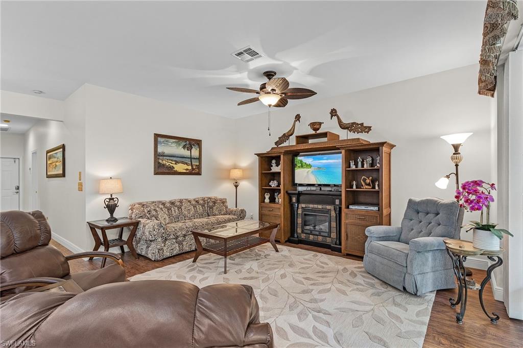 20681 Country Barn Drive Estero, FL 33928 - Photo 27 of 42 a living room with furniture a chandelier and a window