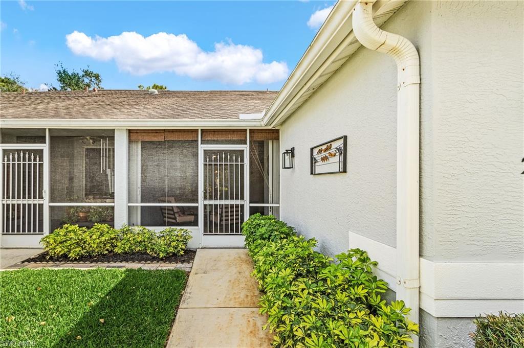 20681 Country Barn Drive Estero, FL 33928 - Photo 3 of 42 a front view of a house with a garden