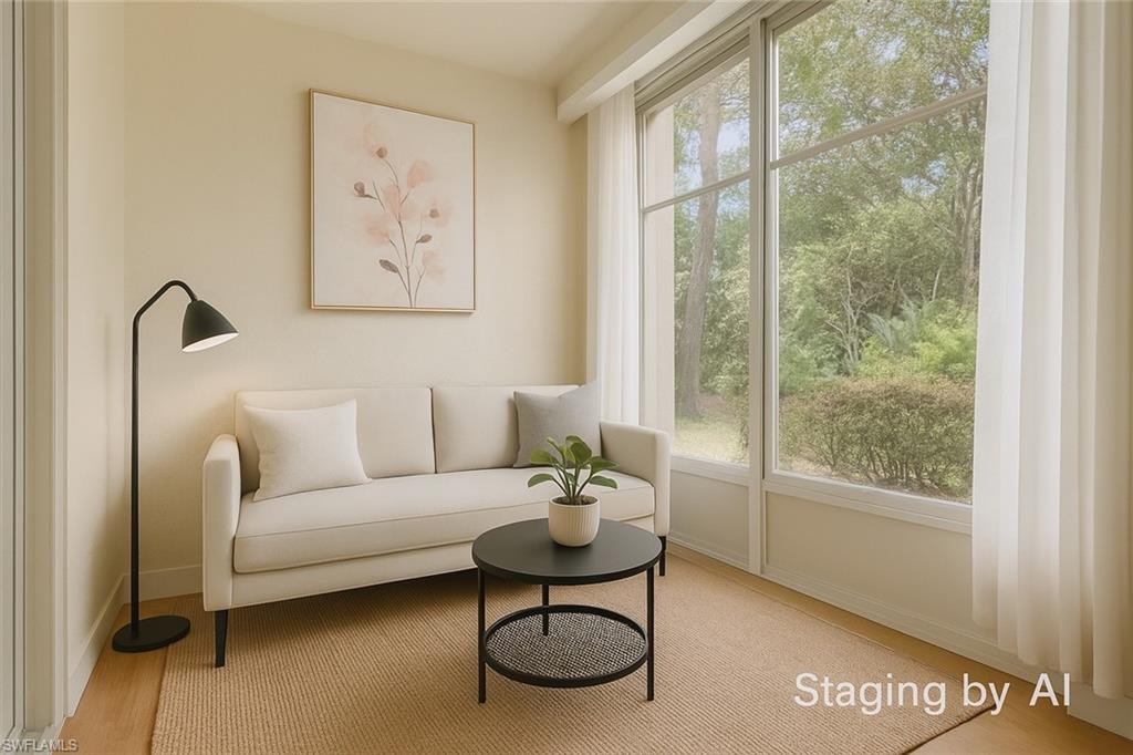 20681 Country Barn Drive Estero, FL 33928 - Photo 33 of 42 a living room with furniture a table and a large window