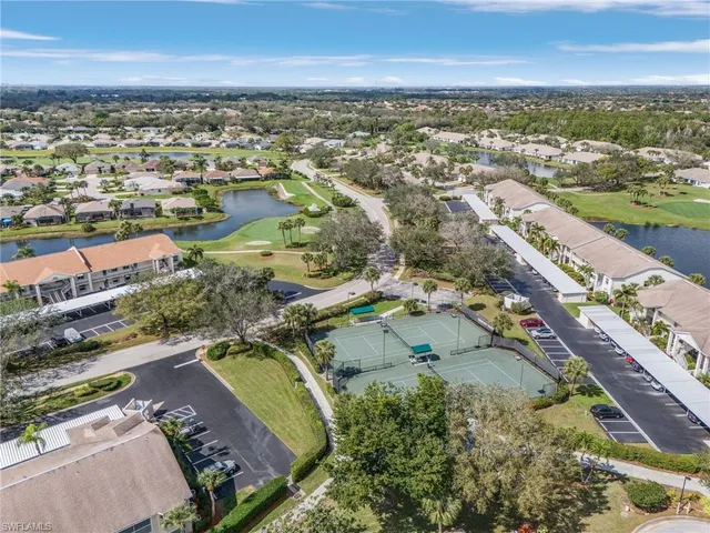 an aerial view of a house with a garden and lake view