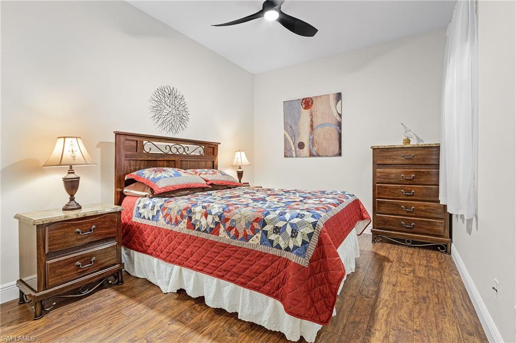 20681 Country Barn Drive Estero, FL 33928 - Photo 7 of 42 a bedroom with a bed and wooden floor