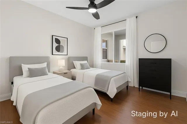 a bedroom with two beds and a potted plant