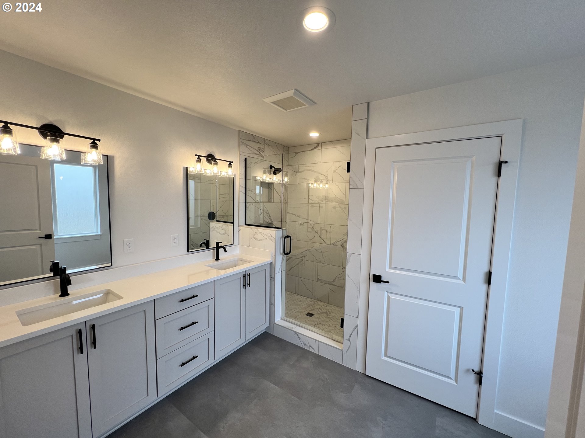 817 Northwest 175th Way Ridgefield, WA 98642 - Photo 17 of 20 a spacious bathroom with double vanity and mirrors