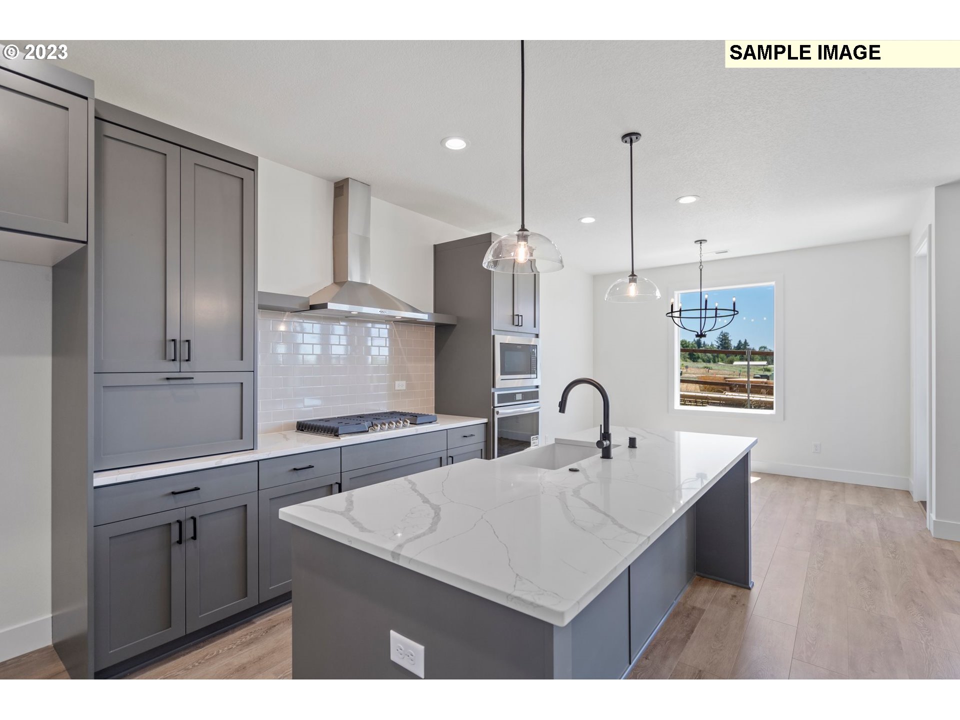 817 Northwest 175th Way Ridgefield, WA 98642 - Photo 5 of 20 a kitchen with kitchen island a sink stove and refrigerator