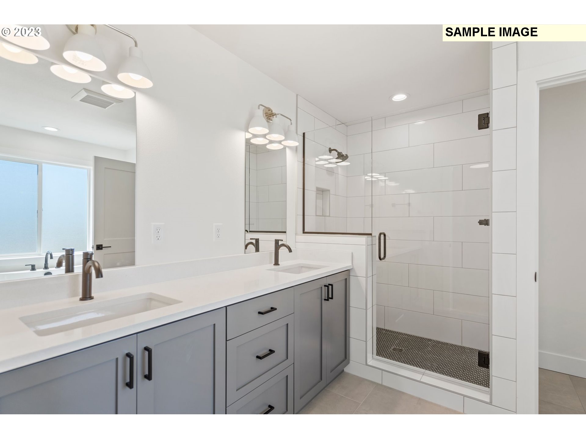 817 Northwest 175th Way Ridgefield, WA 98642 - Photo 10 of 20 a bathroom with a double vanity sink mirror and shower