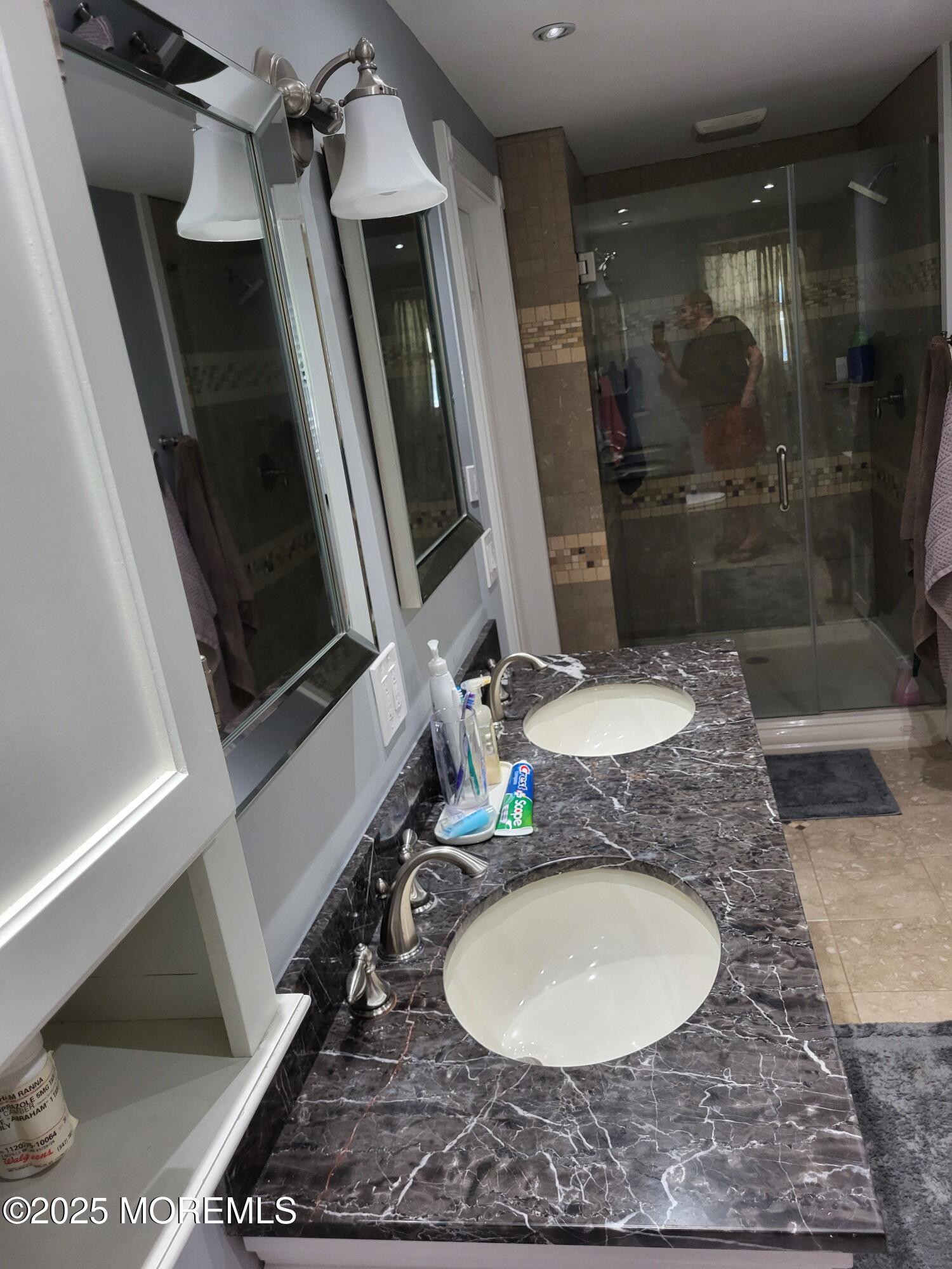 393 Bath Avenue Long Branch, NJ 07740 - Photo 12 of 22 a bathroom with a granite countertop sink a mirror and shower