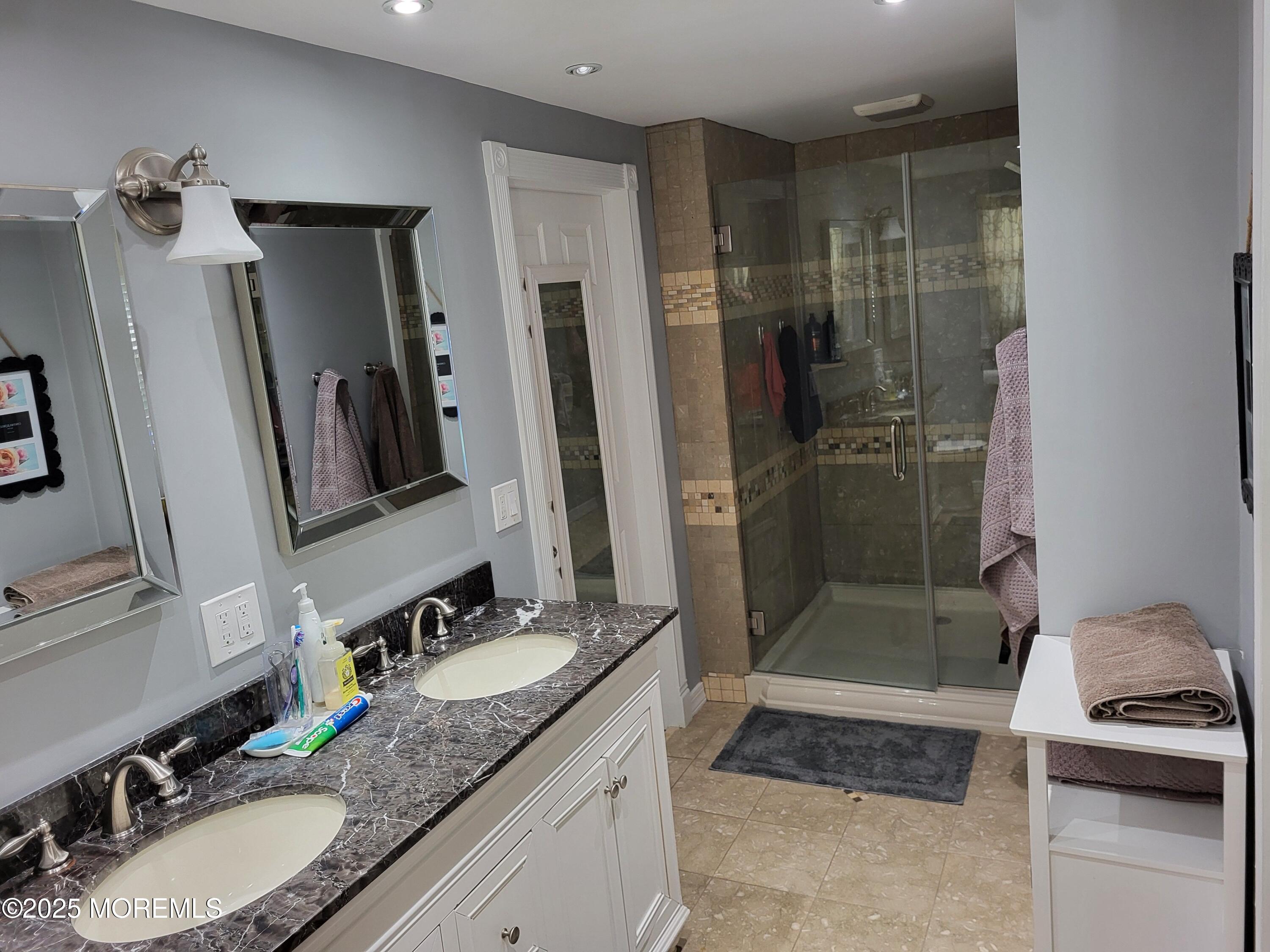 393 Bath Avenue Long Branch, NJ 07740 - Photo 13 of 22 a bathroom with a granite countertop sink shower and a mirror