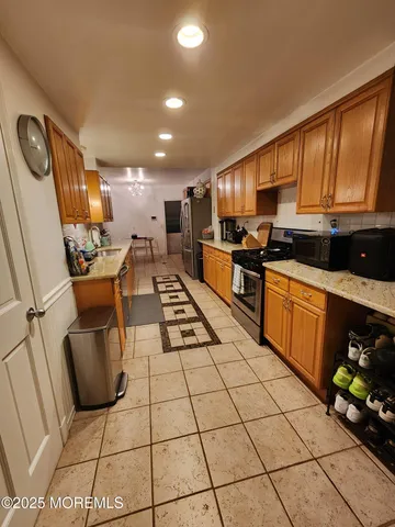 a kitchen with stainless steel appliances kitchen island granite countertop a sink and cabinets