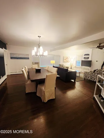 a living room with furniture a dining table and a fireplace